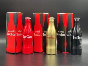 Coca-Cola / 3 Non Official Aluminium Bottles With Box / Red, Gold, Black Image