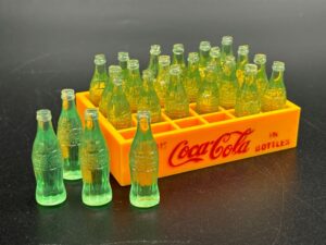 Coca-Cola / Plastic Mini Bottles in Yellow Plastic Crate Image