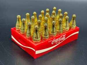 Coca-Cola / Gold Metal Mini Bottles in Red Plastic Crate Image