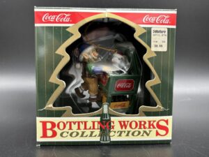 Coca-Cola / Brand Ornaments / Bottling Works Collection / Elf With Penguin Cooler Image